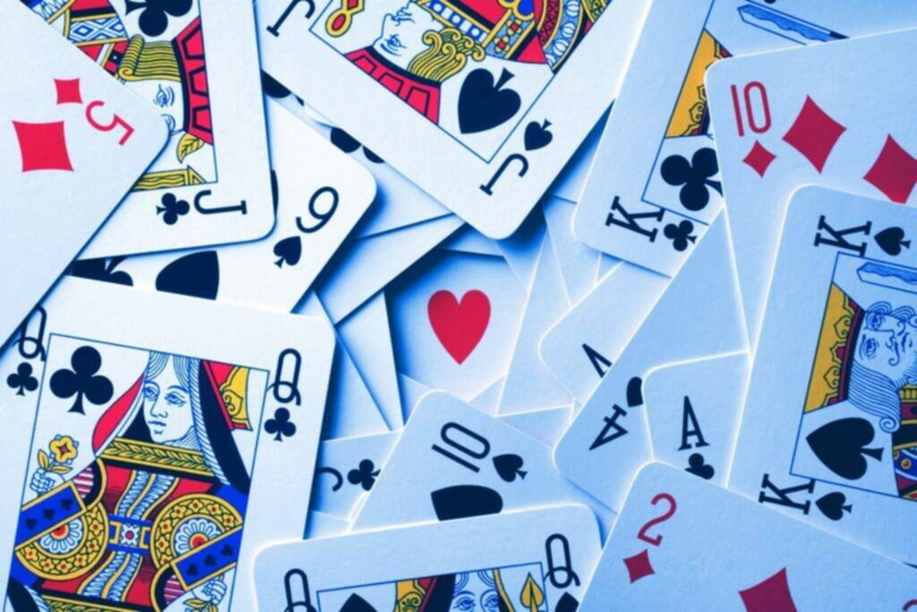 a collection of playing cards featuring various suits and ranks